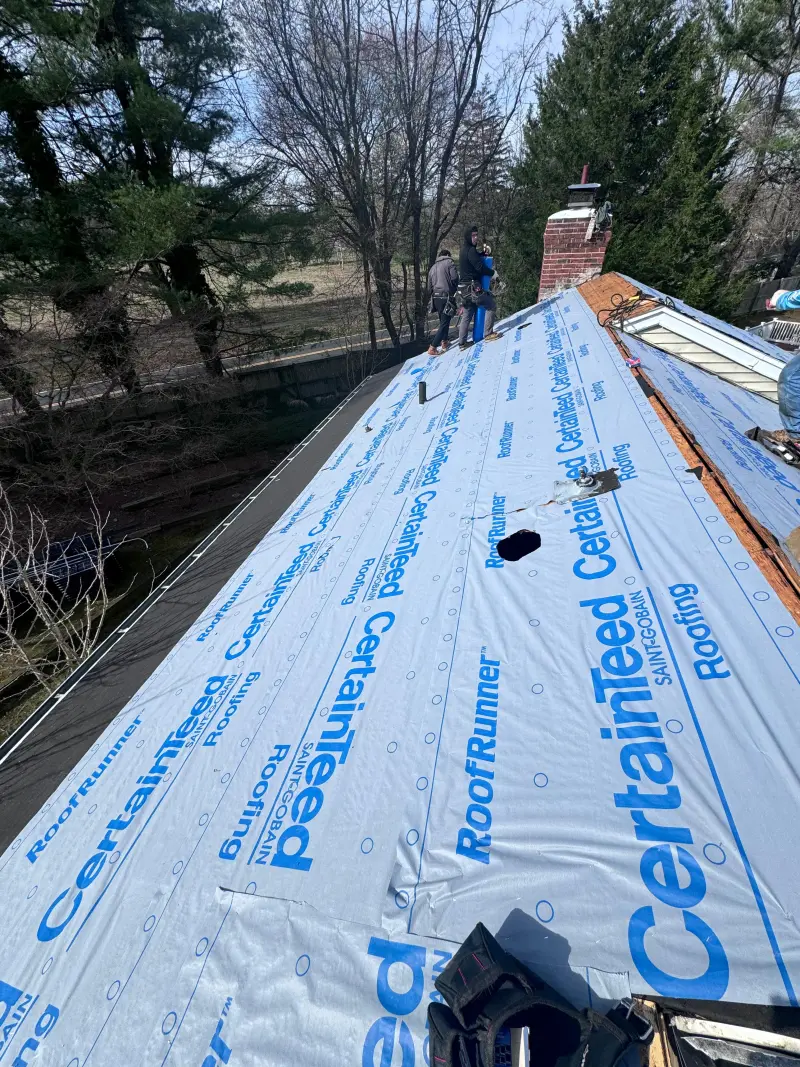 Crew replacing a residential roof