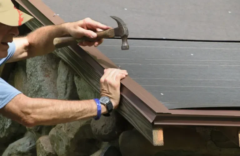A crew member applying drip edge flashing